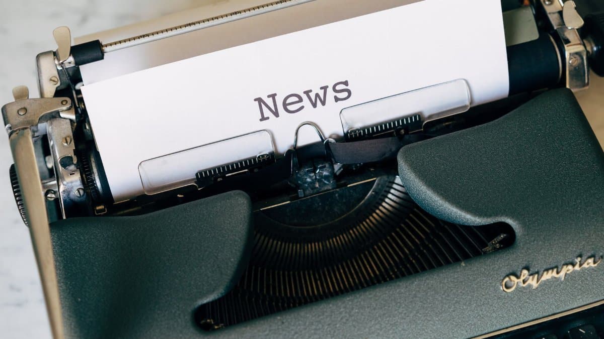 Close-up of a vintage Olympia typewriter with paper reading 'news'. Perfect for classic journalism themes.