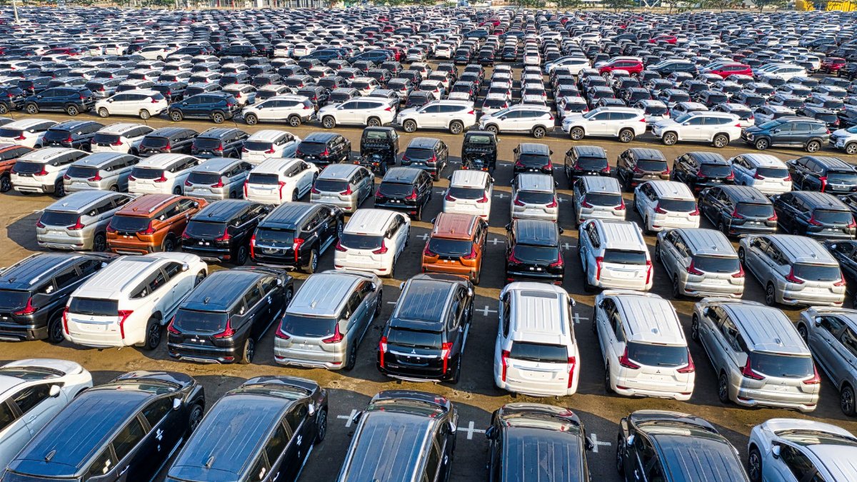 From above of rows with many modern new shiny automobiles of contemporary industry in daytime