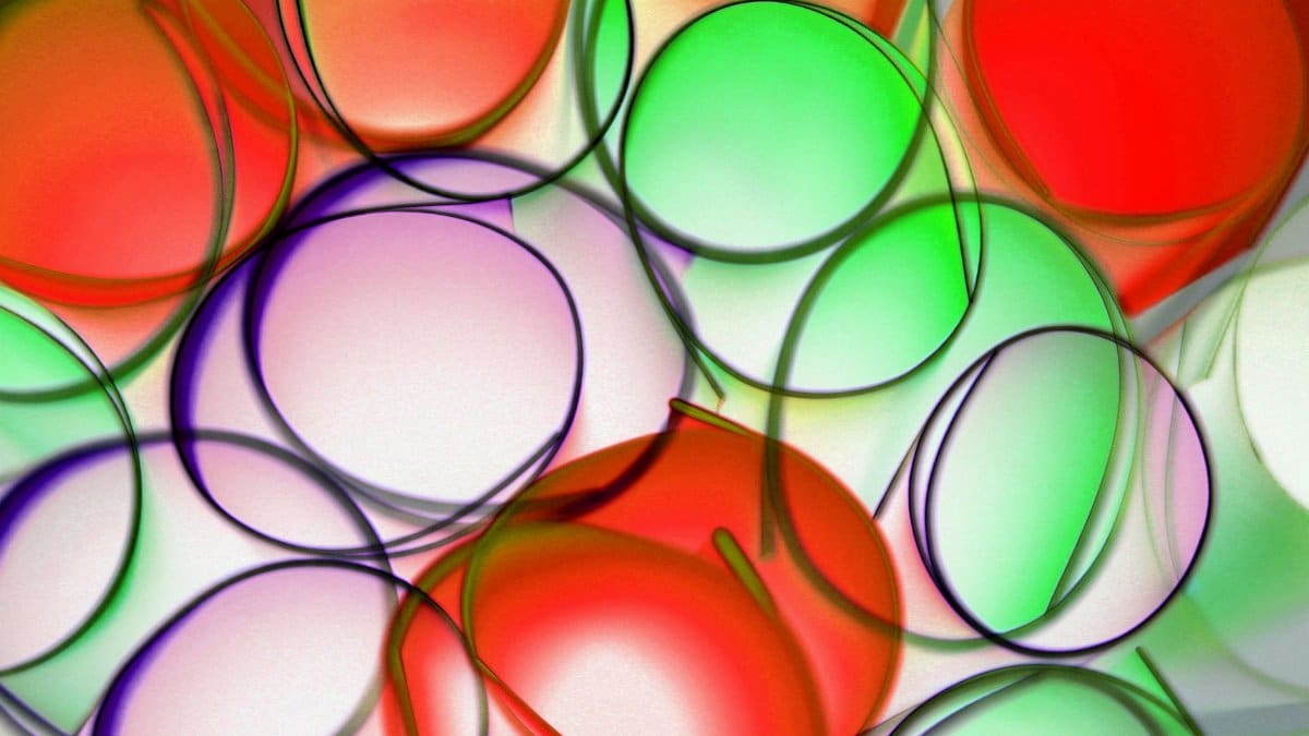 A dynamic abstract design featuring overlapping colorful circles with bright hues.