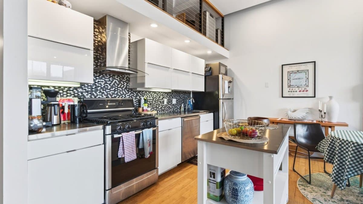 Spacious modern kitchen with sleek design and amenities in a Boston luxury apartment.