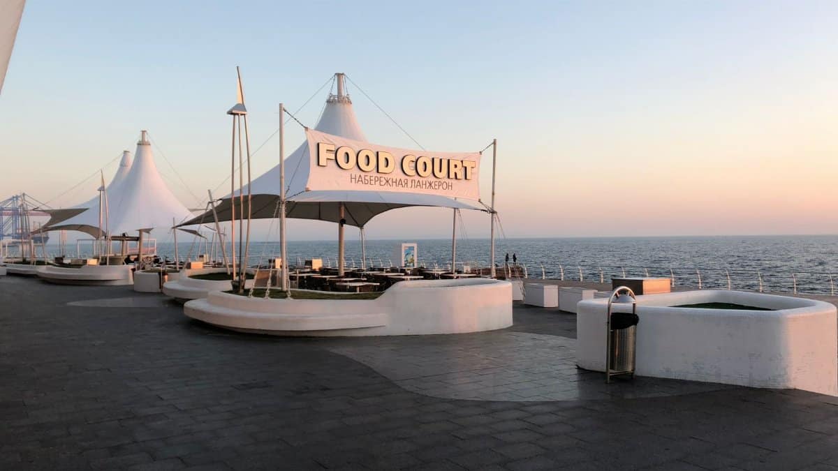Peaceful sunset view of Langeron Beach Food Court in Odesa, Ukraine, with ocean in the background.