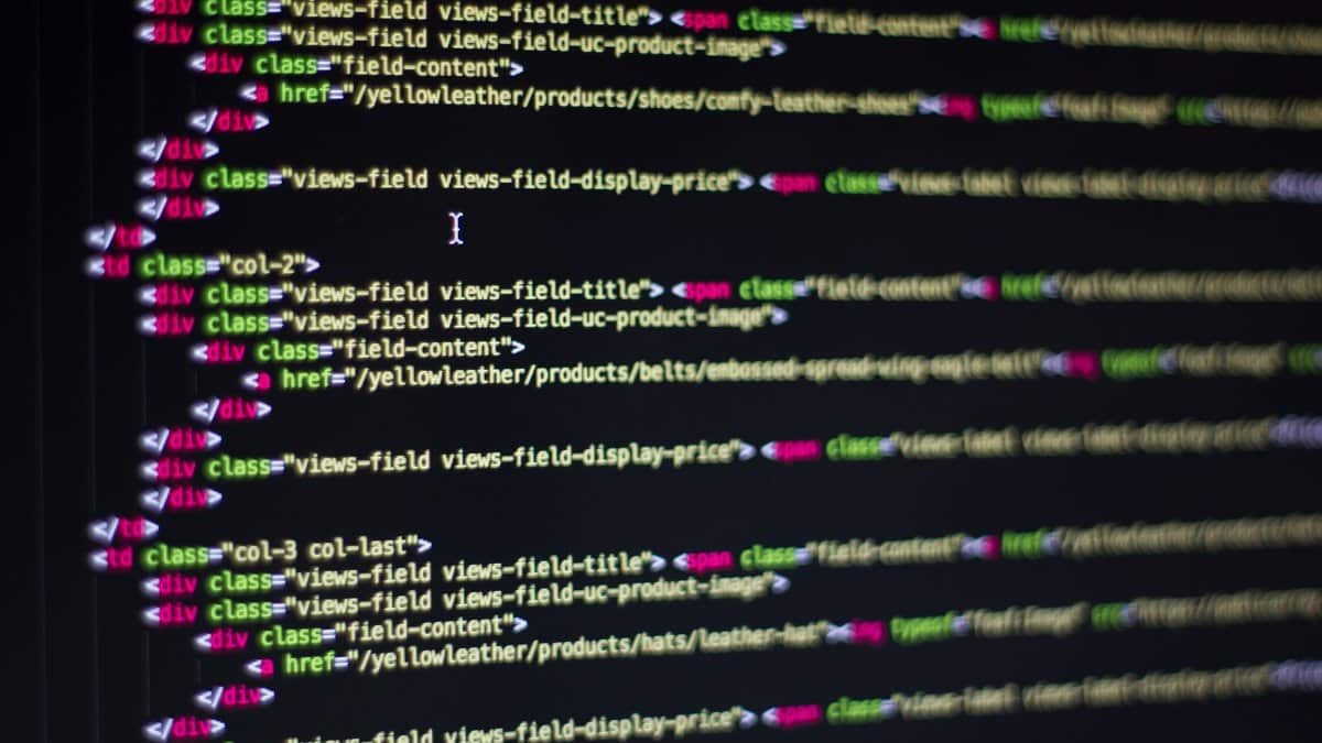 Detailed close-up of HTML code on a computer monitor, showcasing web development.