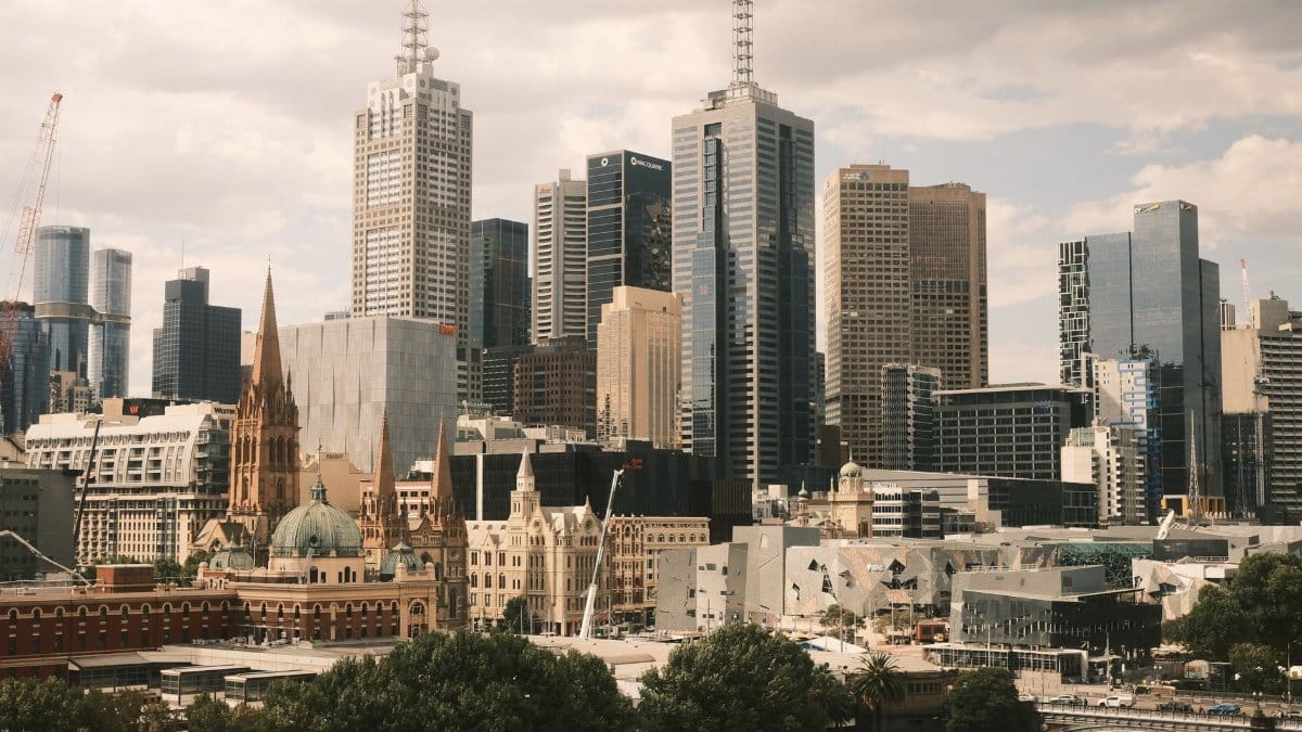 Stunning aerial view of Melbourne city skyline, showcasing modern skyscrapers and historic architecture.