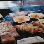 Grilled Japanese skewers and seafood sizzling on an open barbecue in Nagano, Japan.