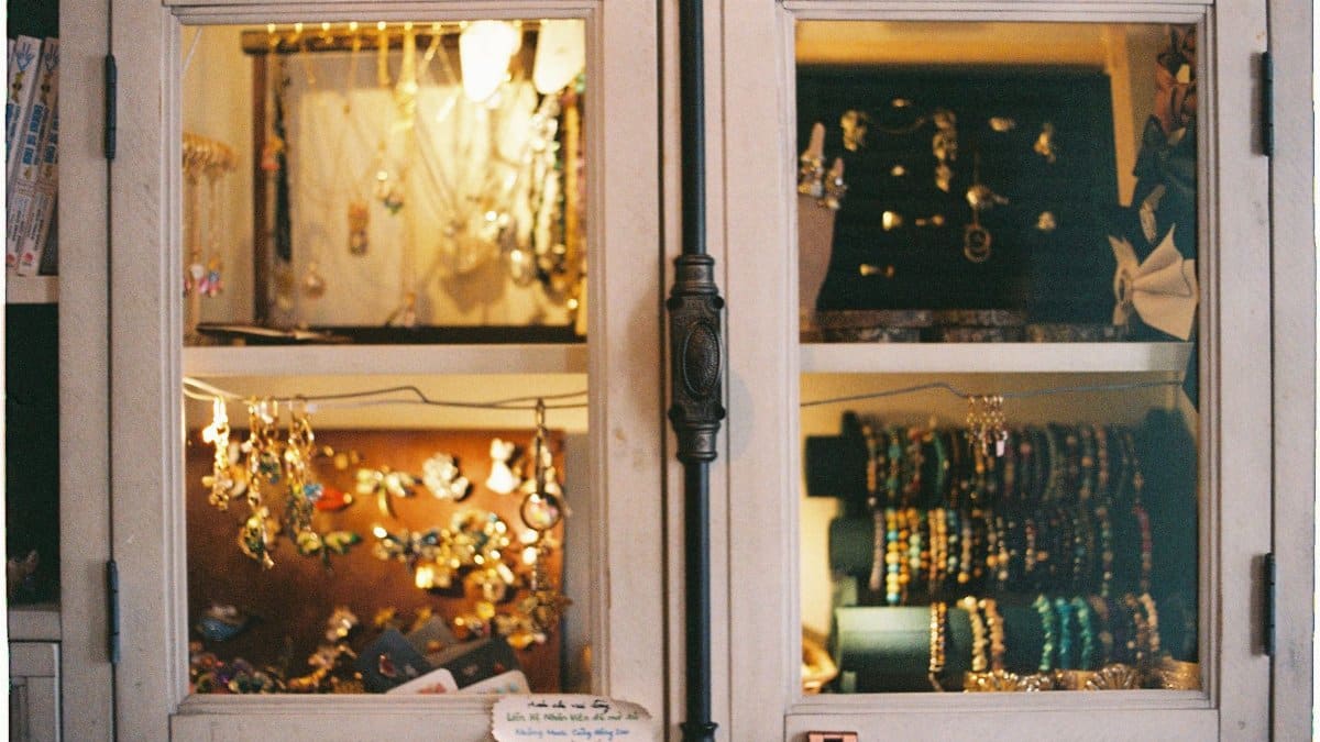 A warm, inviting display of jewelry inside a vintage wooden cabinet.