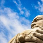 Close-up of the Martin Luther King Jr. Memorial statue against a blue sky in Washington, D.C.