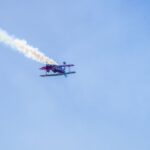 Aerobatic airplane flying with smoke trail during airshow in Buenos Aires, Argentina.