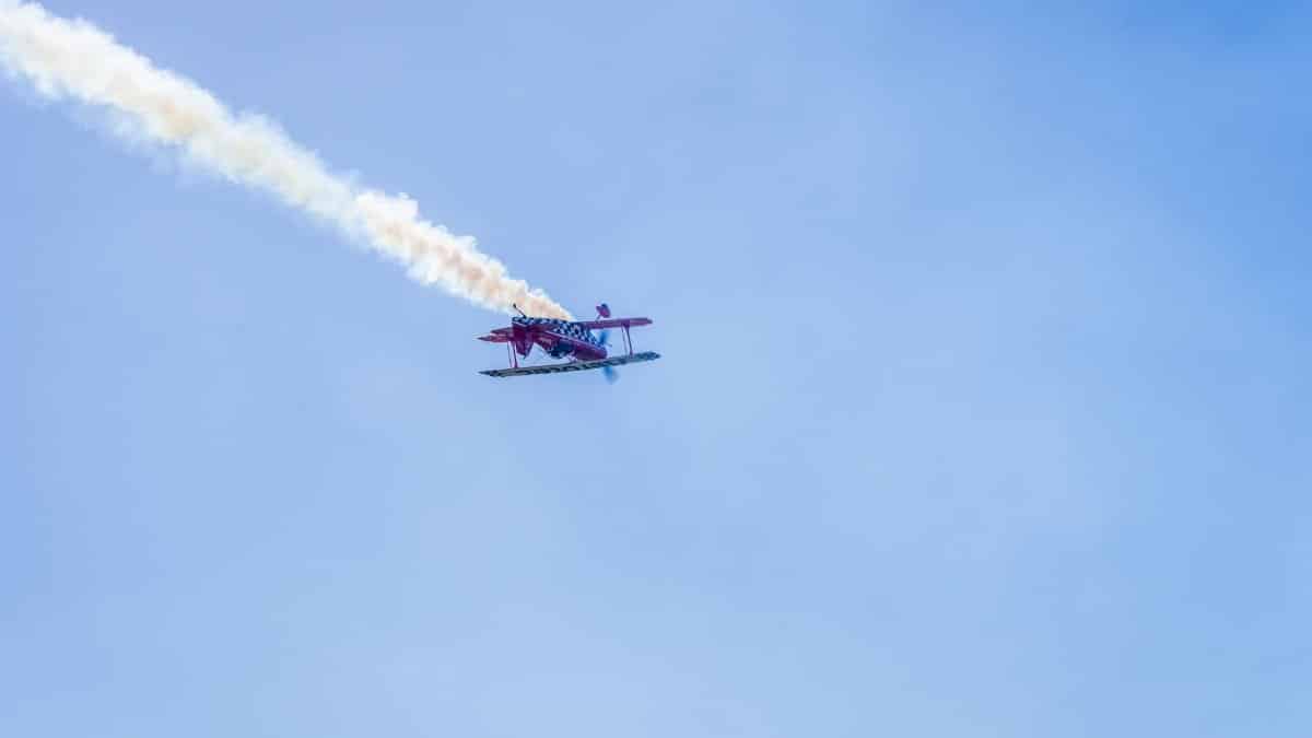 Aerobatic airplane flying with smoke trail during airshow in Buenos Aires, Argentina.