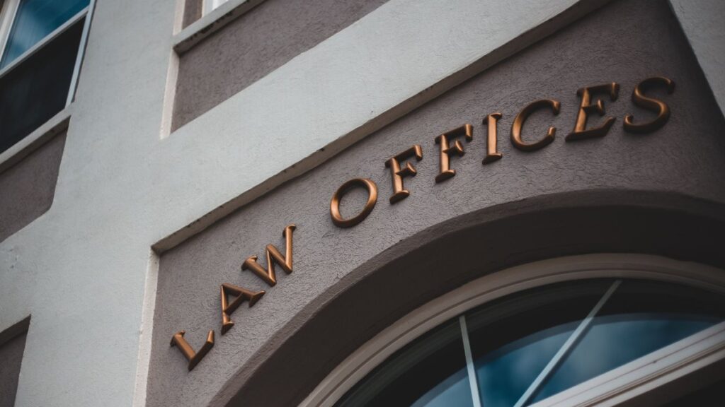 Low angle view of a modern law office exterior with elegant facade and arched entrance.