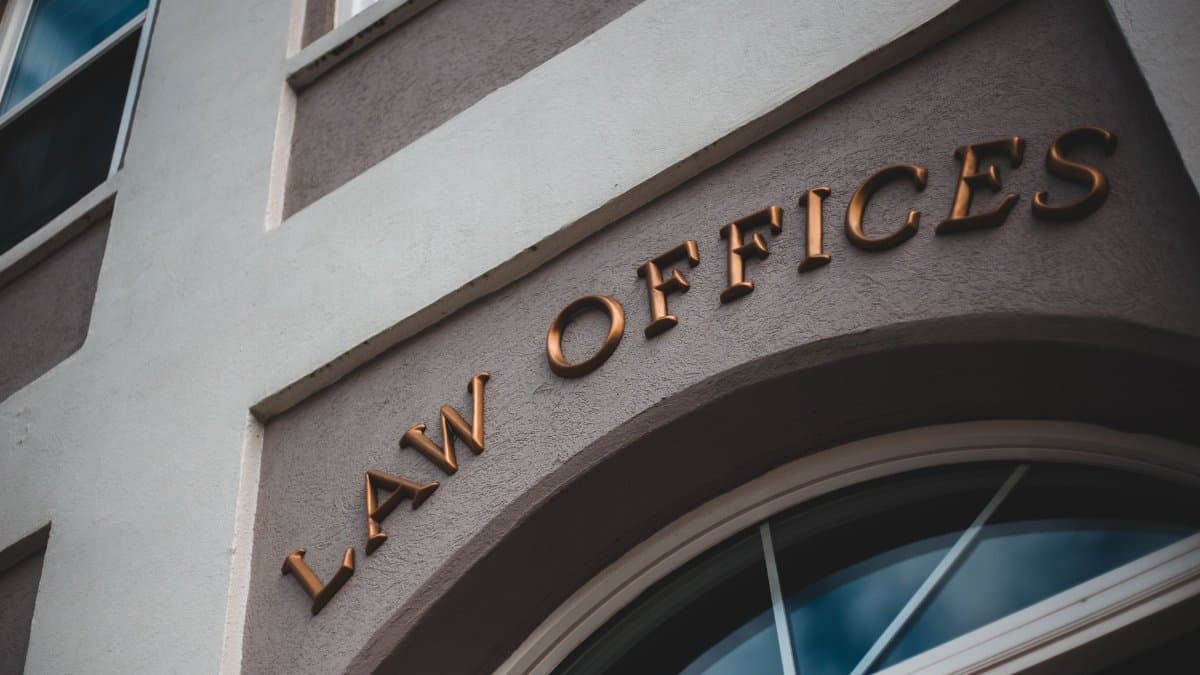 Low angle view of a modern law office exterior with elegant facade and arched entrance.