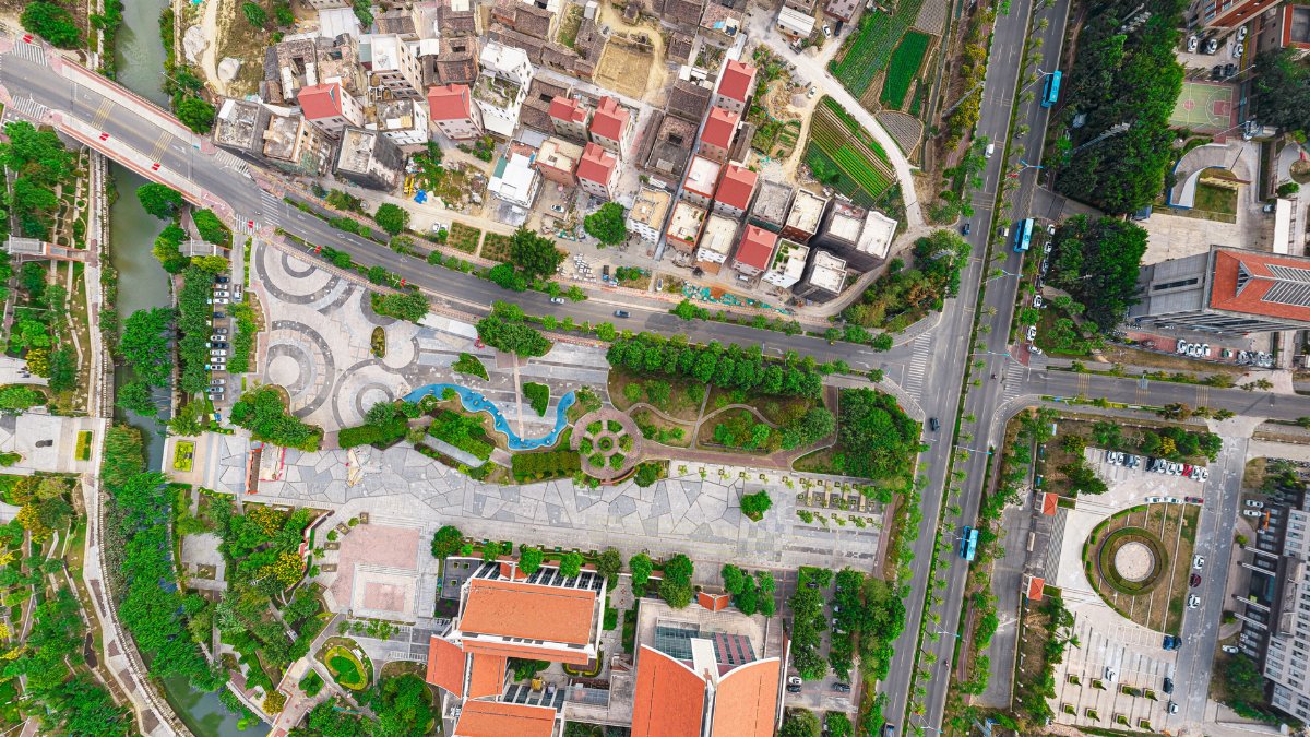 A stunning aerial view of an urban landscape showing roads, greenery, and buildings.