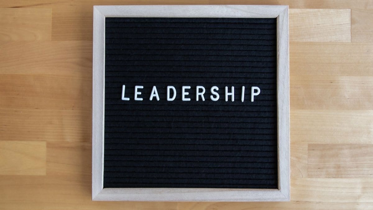 Black letter board displaying the word 'Leadership' on a wooden surface.