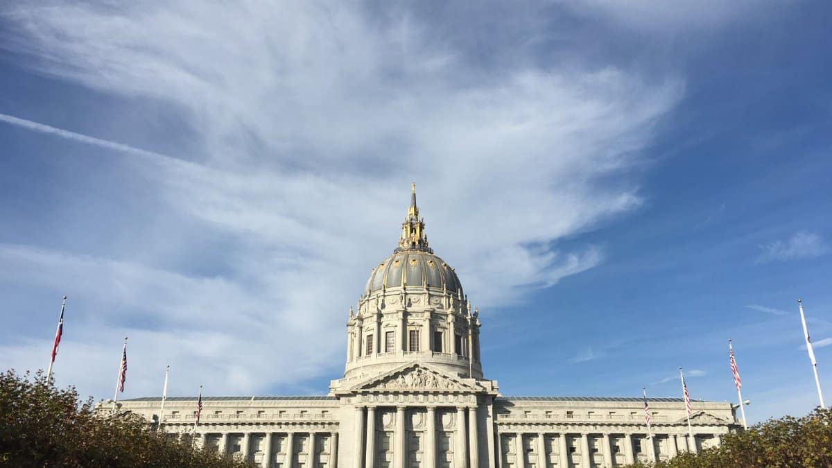 Majestic view of San Francisco City Hall with clear blue sky and classic architecture.