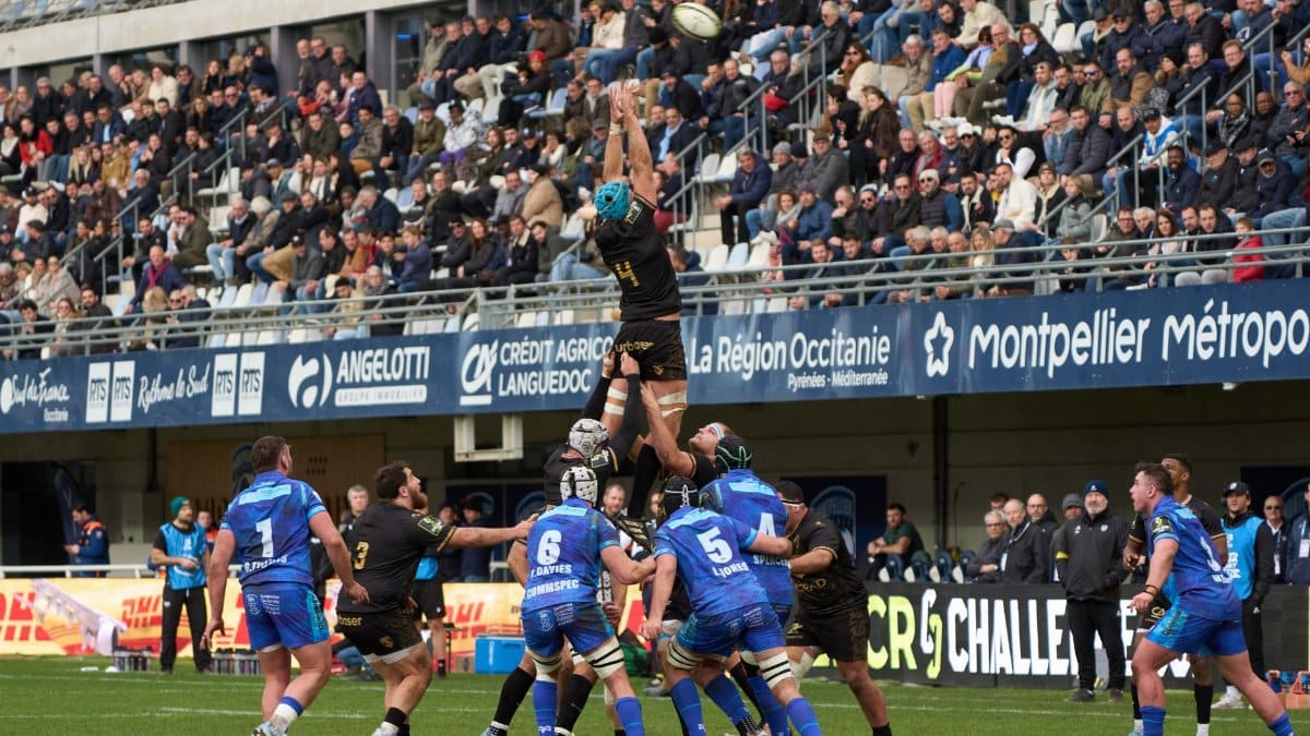 Exciting rugby match with crowds cheering at a stadium in Montpellier, Occitanie, France.