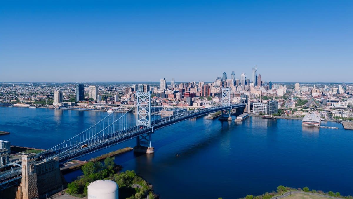 Stunning aerial shot overlooking the Benjamin Franklin Bridge and Philadelphia skyline on a clear day.