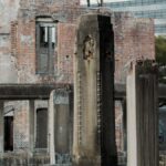 Ancient stone columns standing amidst the ruins of a historic building, showcasing a blend of history and decay.
