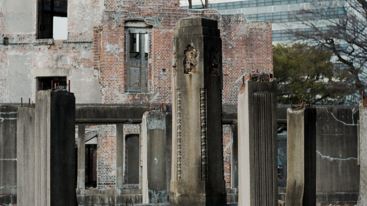 Ancient stone columns standing amidst the ruins of a historic building, showcasing a blend of history and decay.