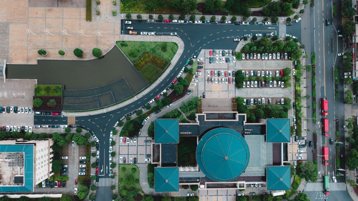 Top-down aerial view of a city intersection showcasing modern architecture and urban planning.