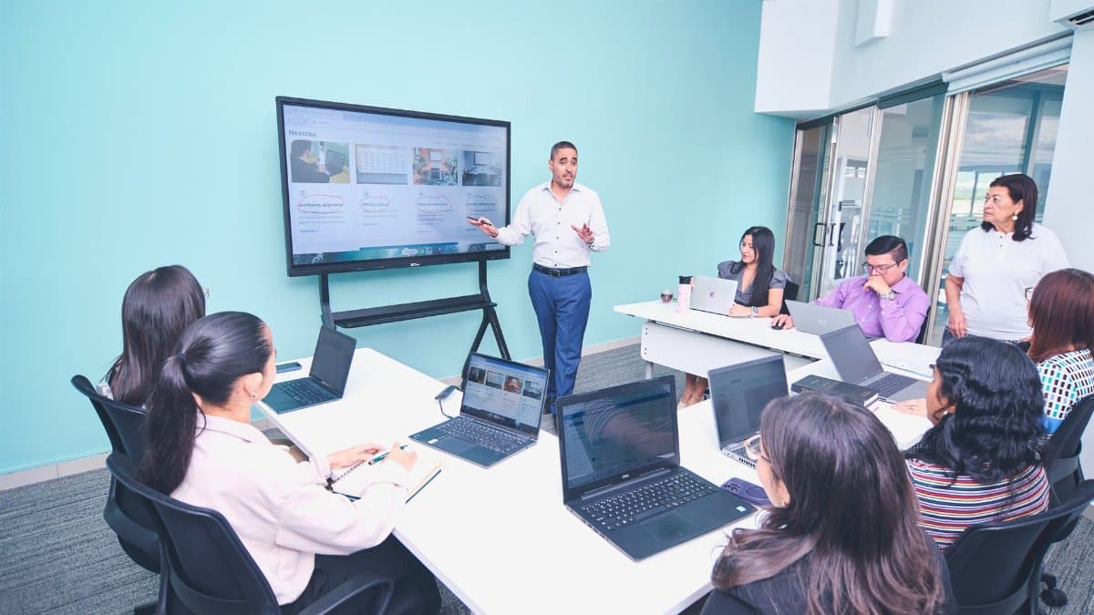Team engaged in a presentation at a modern office using digital technology.