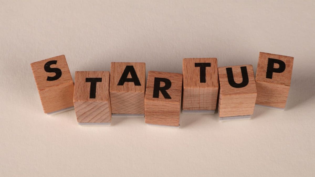 Wooden blocks forming the word 'STARTUP' on a neutral background, symbolizing new business ventures.
