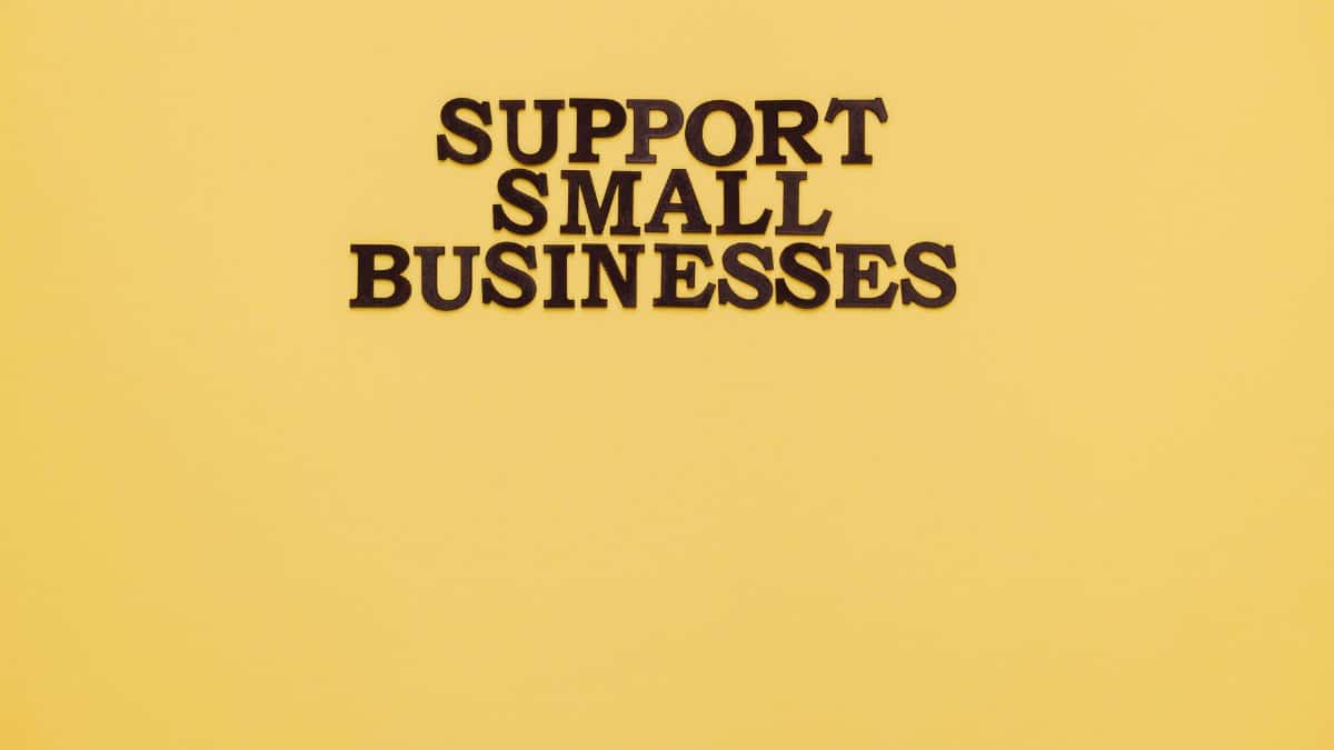 Inspirational image with 'Support Small Businesses' text on a warm yellow background.