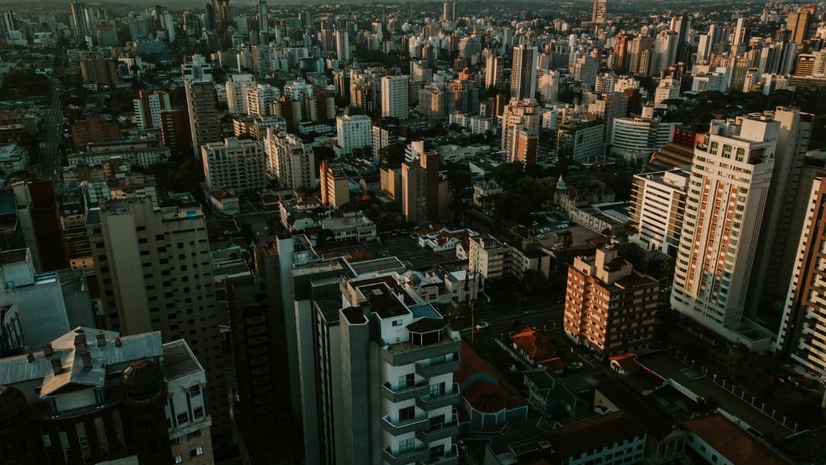 Stunning aerial view of Curitiba skyline at sunset featuring modern skyscrapers.
