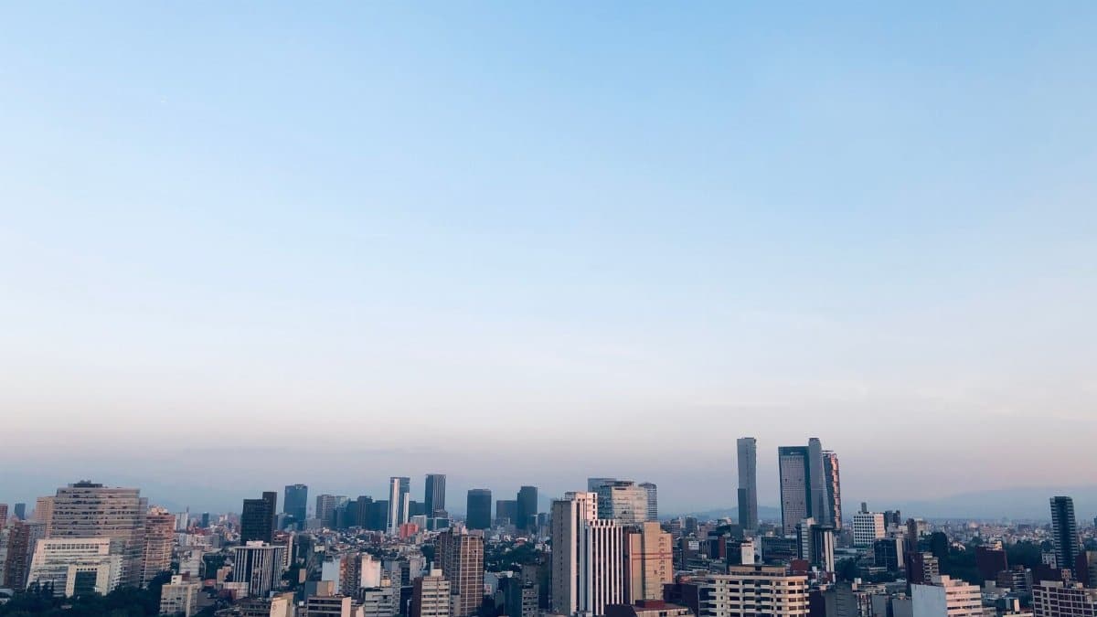 Beautiful aerial view of Mexico City's skyline with skyscrapers under a clear blue sky.
