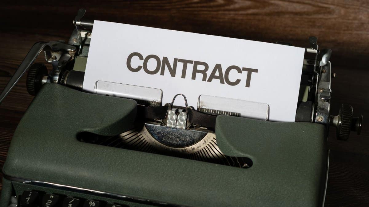 Close-up of a vintage typewriter with a paper labeled 'Contract', evoking a retro office theme.