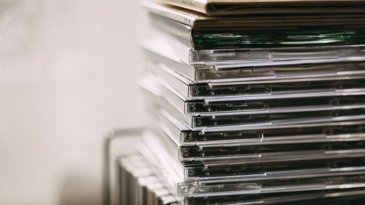 A stack of transparent CD cases neatly aligned, creating a still life composition.
