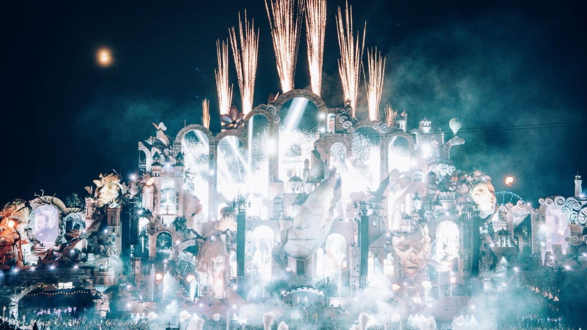 Dazzling fireworks light up Tomorrowland's grand stage in Boom, Belgium, at night.
