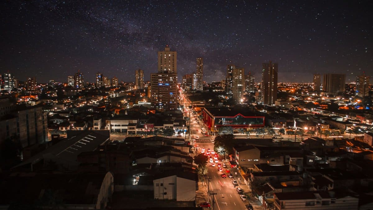 Captivating night cityscape of Nazaré, Brazil, showcasing vibrant urban lights and a starry sky.