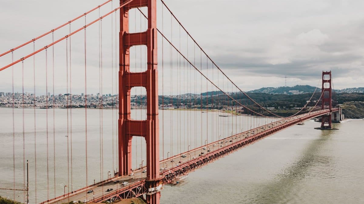 The iconic Golden Gate Bridge spans the San Francisco Bay under a moody sky.