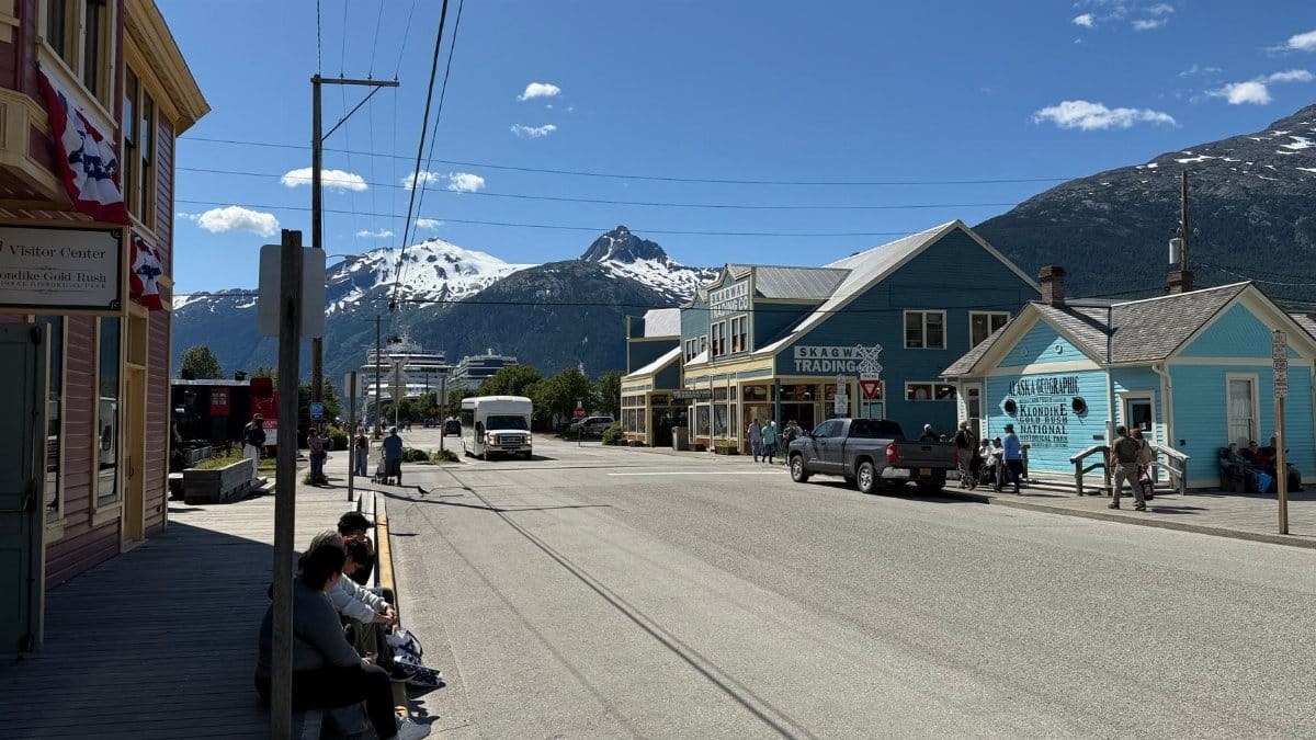 Explore Skagway, Alaska with mountain views, local shops, and a lively street scene.