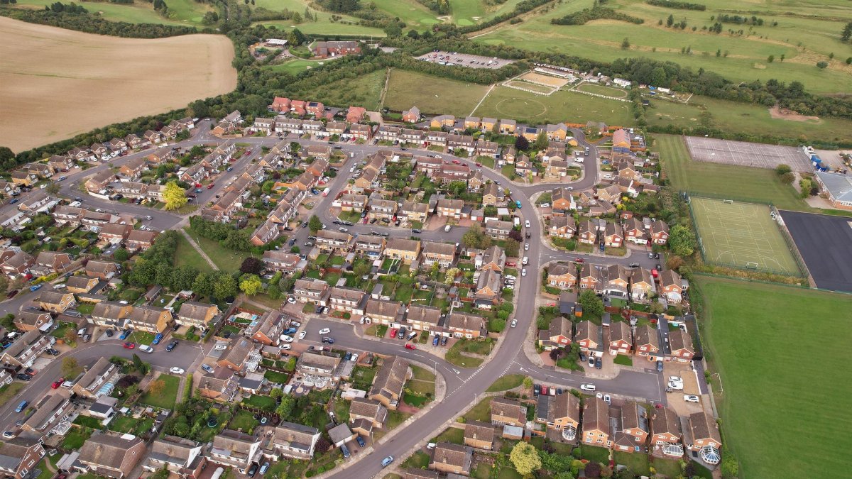 Aerial shot of a residential area in Luton, England surrounded by countryside.
