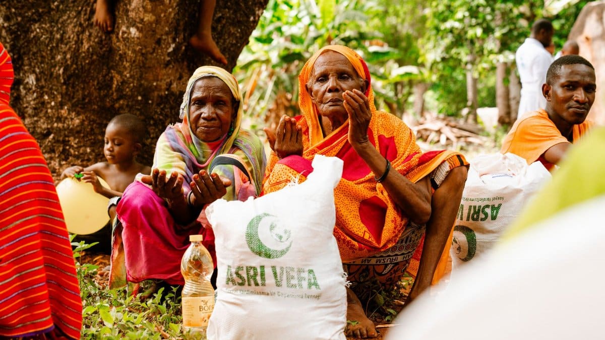 People gathered outdoors for food distribution, showcasing community support and aid.