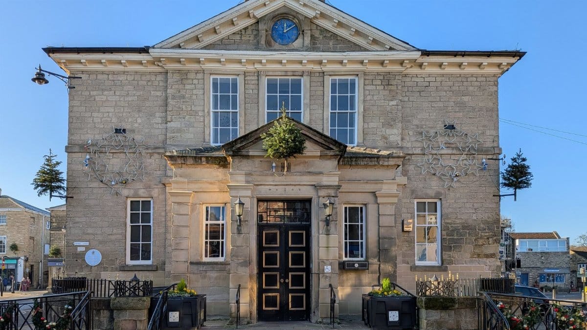 Front view of Wetherby Town Hall on a sunny day, showcasing classic architecture.