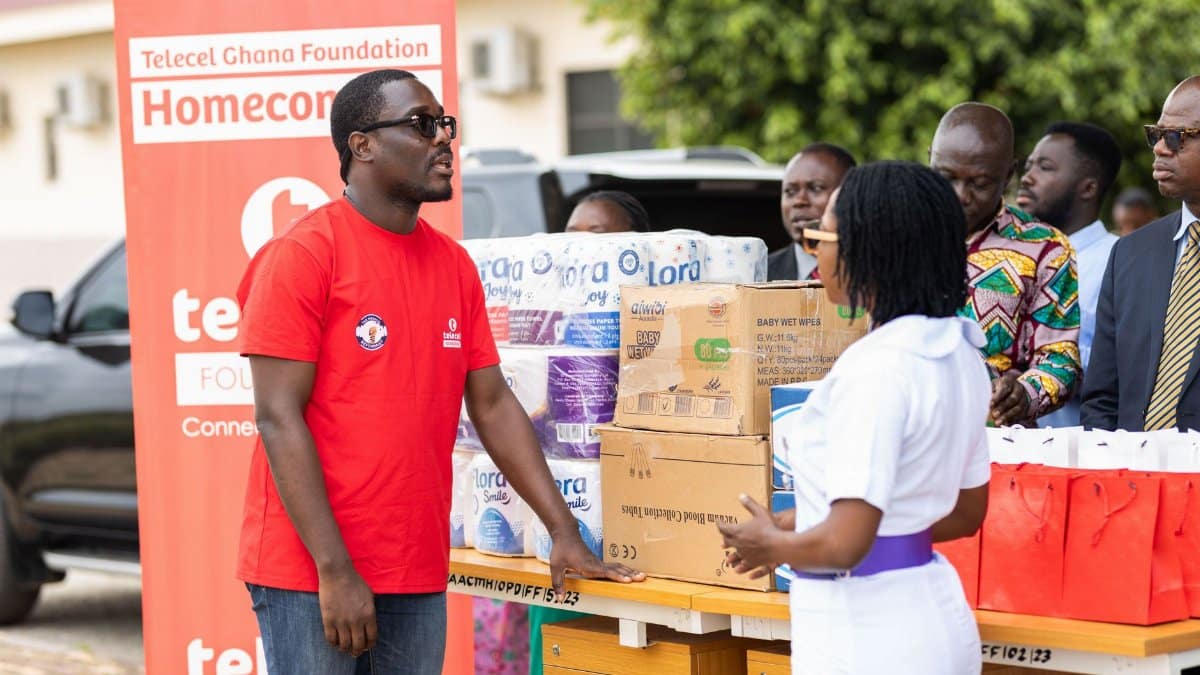Community members participate in an outdoor charity event distributing essential supplies.
