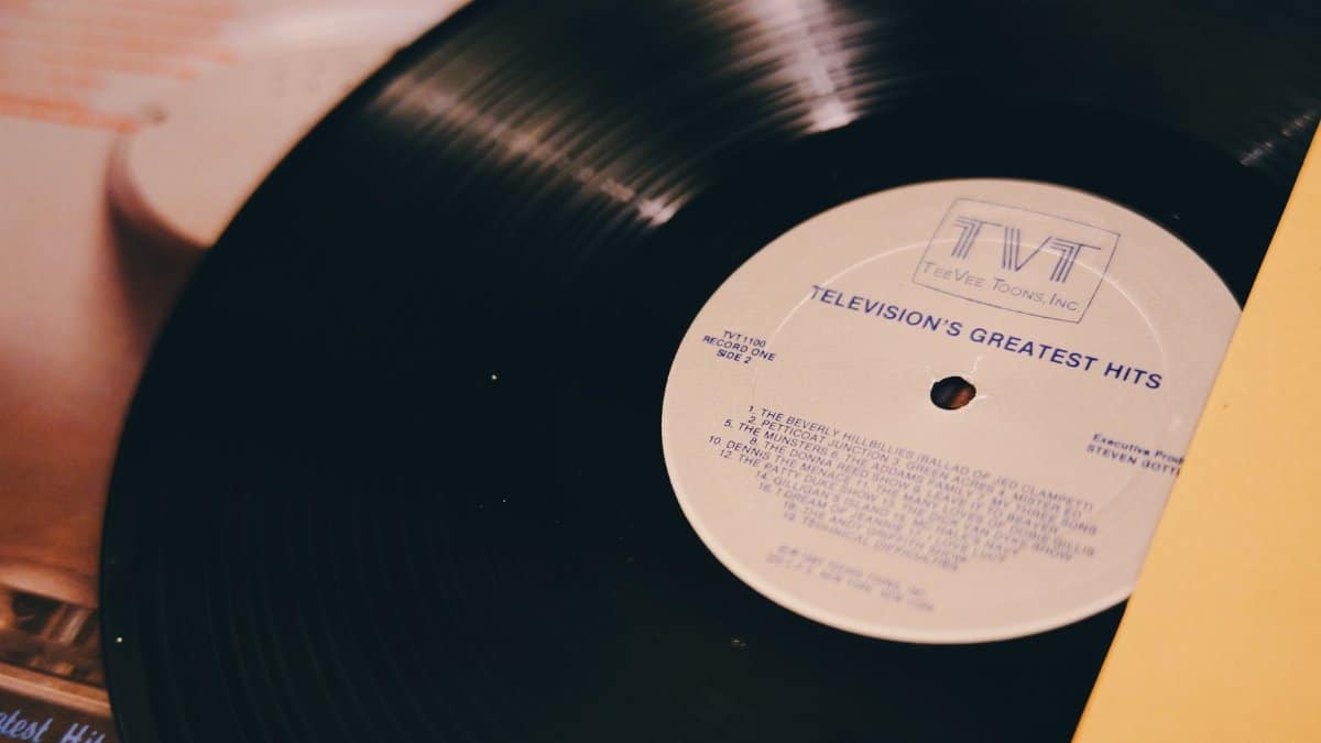 A vintage vinyl record titled 'Television's Greatest Hits' on a turntable.