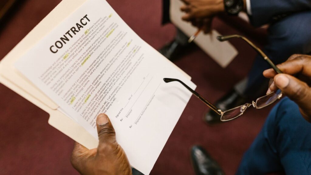Close-up of hands holding a contract, focus on business agreement discussion.