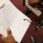 Close-up of hands holding a contract, focus on business agreement discussion.
