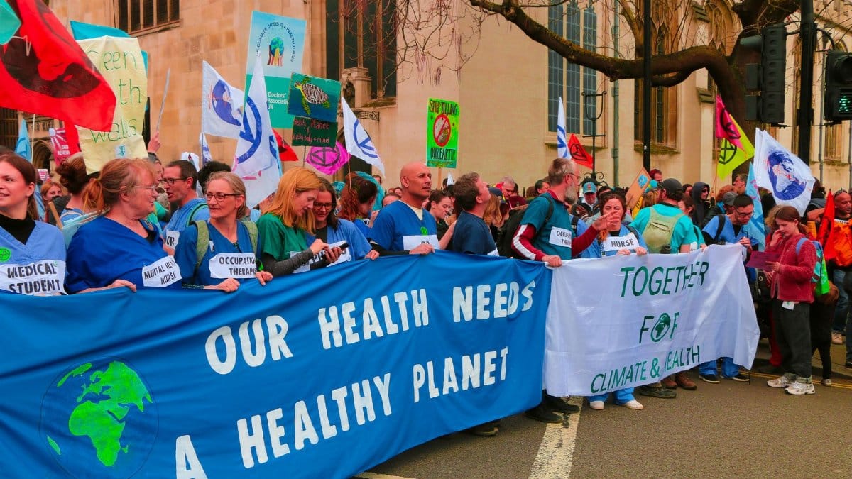 A vibrant protest in London advocating for climate change awareness and health.