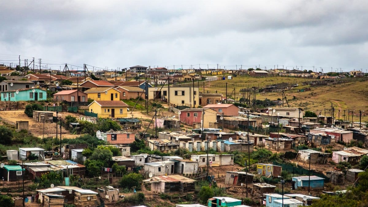 Charming rural village with colorful houses under a cloudy sky, capturing a scenic rural community.