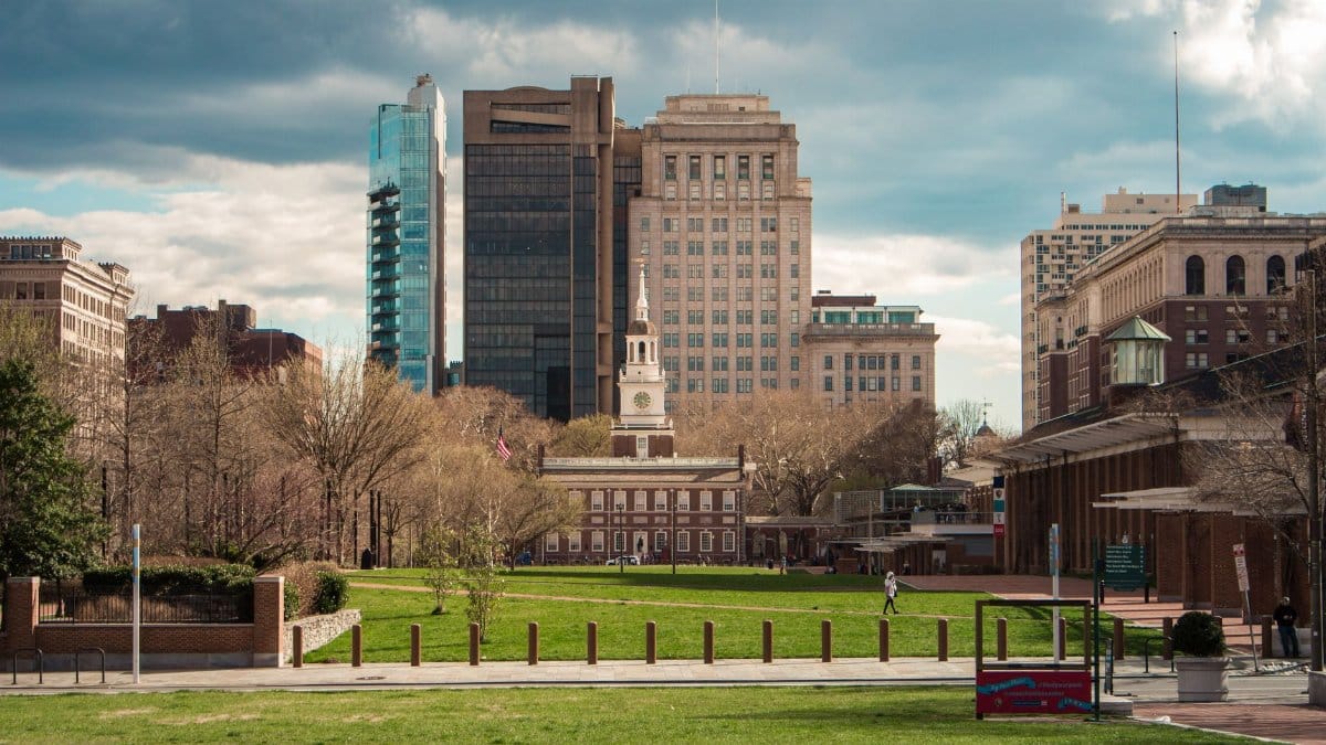 Scenic view of Independence Hall with modern Philadelphia skyline in the background.