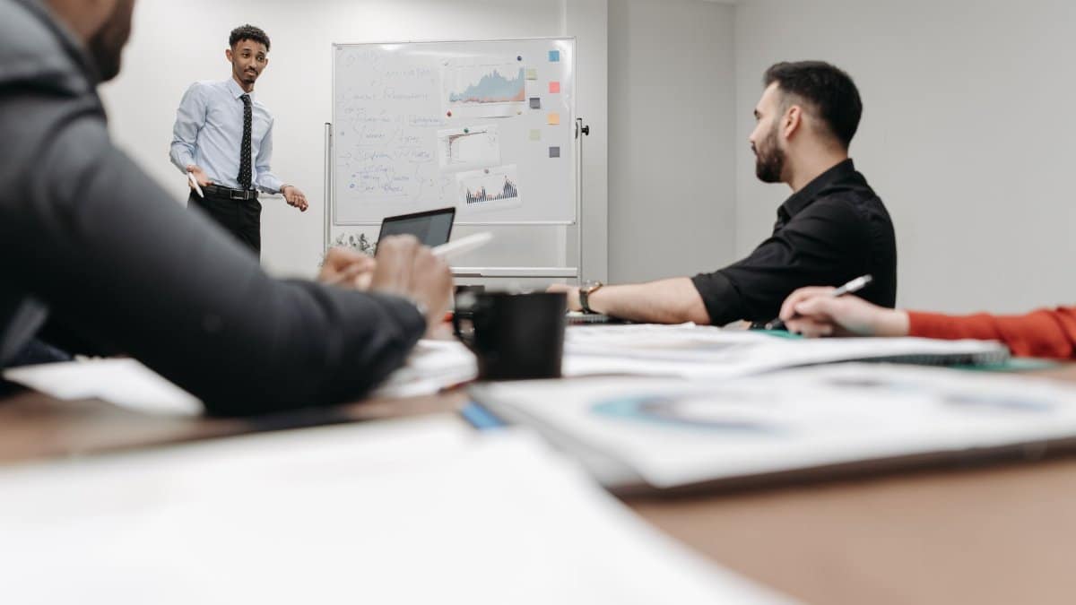 Corporate team during a presentation in an office setting, featuring discussions and planning.