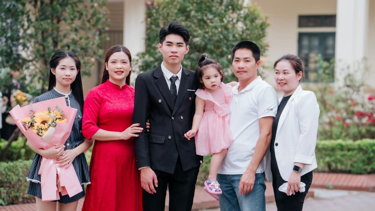 A joyful family group posing together outdoors, showcasing love and celebration.