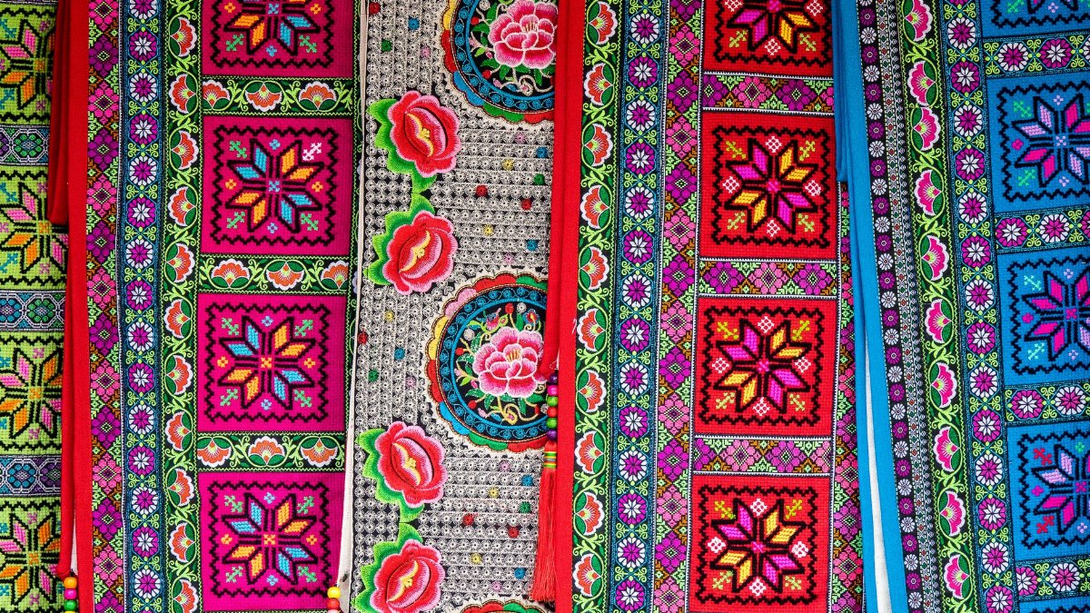 A vivid showcase of traditional ethnic textile patterns with intricate designs and bold colors.