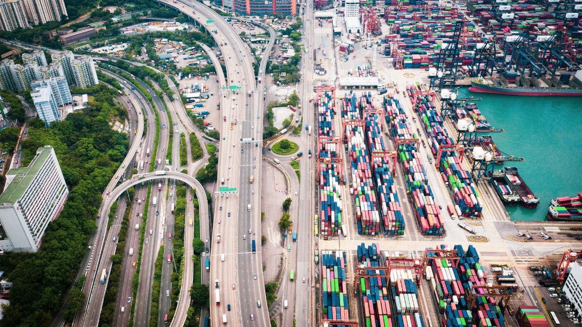 Aerial shot of Hong Kong's vibrant container port and expressway network, highlighting urban infrastructure.