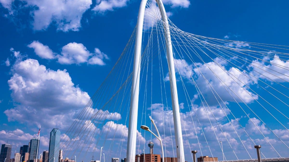 Margaret Hunt Hill Bridge against a vibrant Dallas skyline, showcasing modern architecture.
