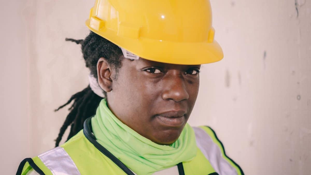 Engineer wearing safety gear looking confidently ahead, emphasizing construction work.