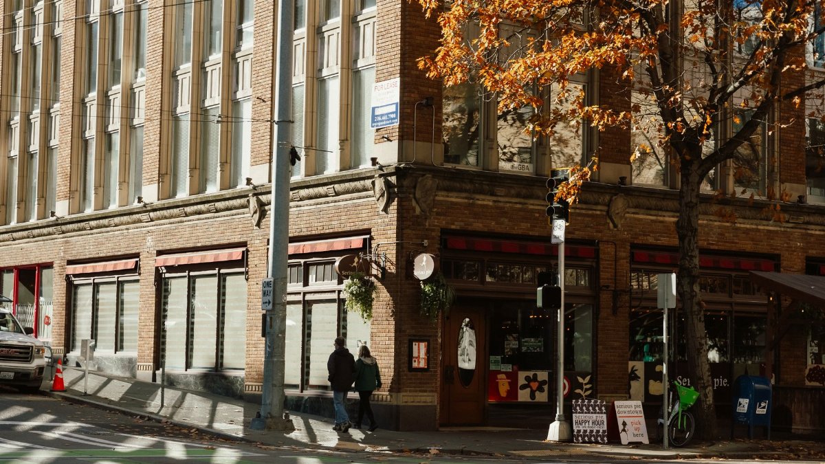Autumn leaves near an urban corner building in Seattle, Washington.